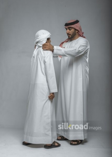 Arabian man giving advice to his son