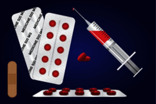 syringe with bandages and pills against blue background