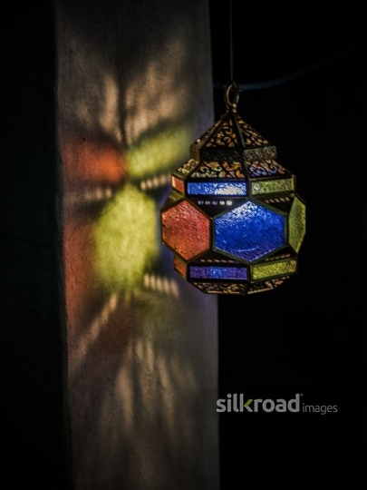 Colourful lantern reflecting on the wall|-