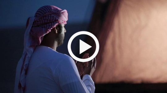 Close-up of young man praying outside