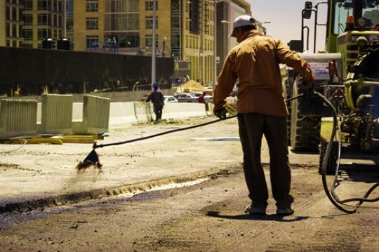 worker cleaning the sidewalk