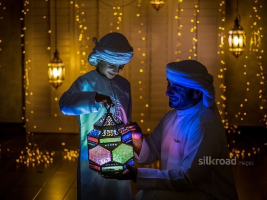 Father and son holding lantern|-