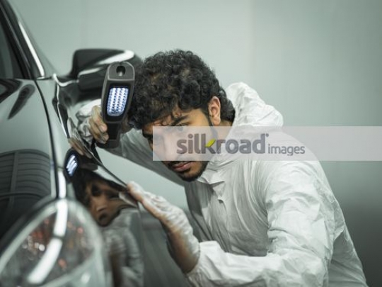 Workers checking the car|