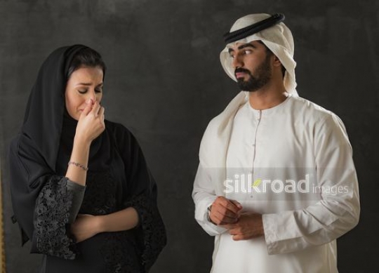 Arab woman upset standing next to the Arab man|