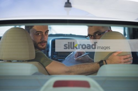 Arab men looking back to reverse|