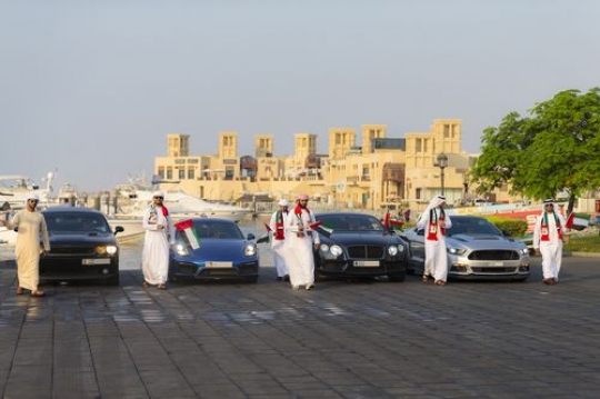 Arab men representing their country during the UAE National Day|-
