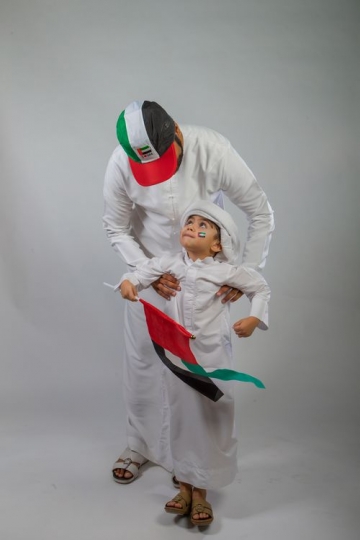 Portrait of a middle eastern man and boy celebrating National Day
