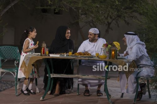 Arab family sitting together during Iftar|-