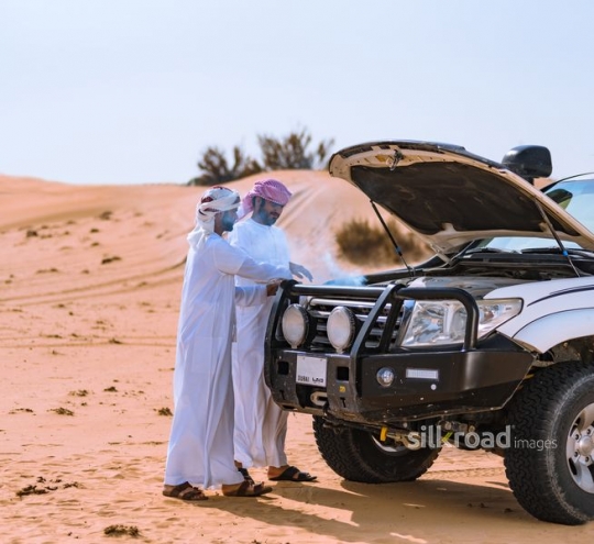 Men checking car damage