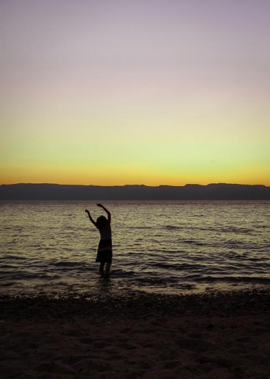 kid swinging arms in the water
