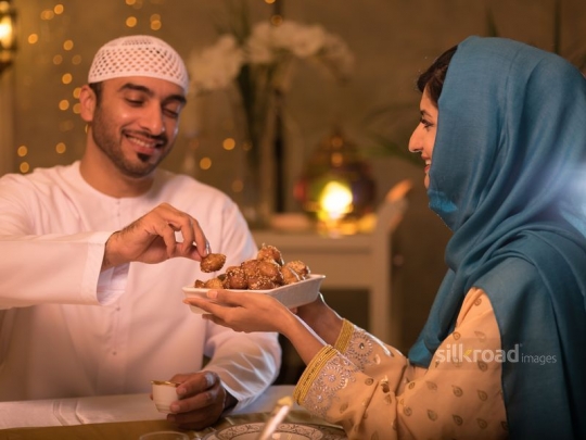 Wife serving Arabic sweets|-