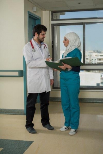 A Doctor and Nurse Discussing 