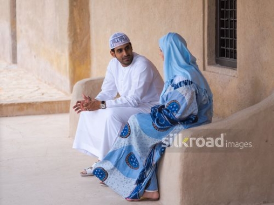 Couple sitting outside|-