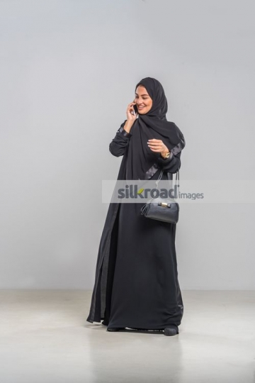 Woman standing talking on the phone