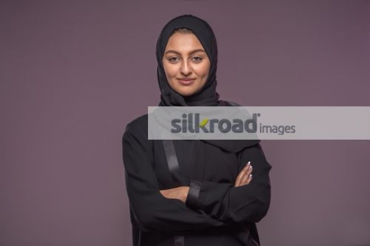 Arab woman standing arms crossed|