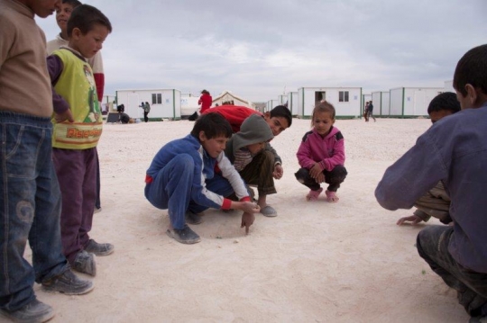 group of children playing glass ball from Zaatari refugee camp for Syrian refugees