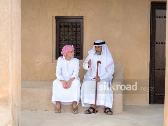 Teenager chatting with grandfather|-