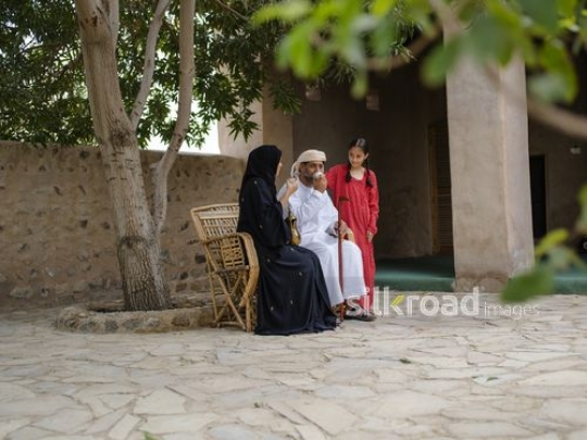 Drinking coffee under the tree