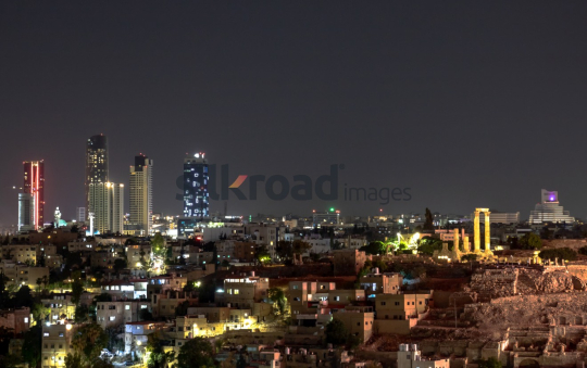 Nighttime View of Amman: Modern Skyline and Historical Ruins