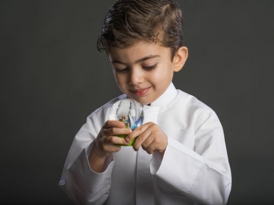 Little boy holding snowball