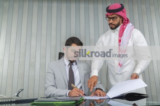 Businessman telling the boss where to sign|