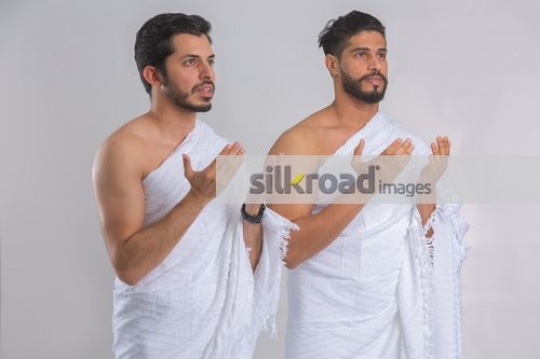 Medium shot of Arab men praying|