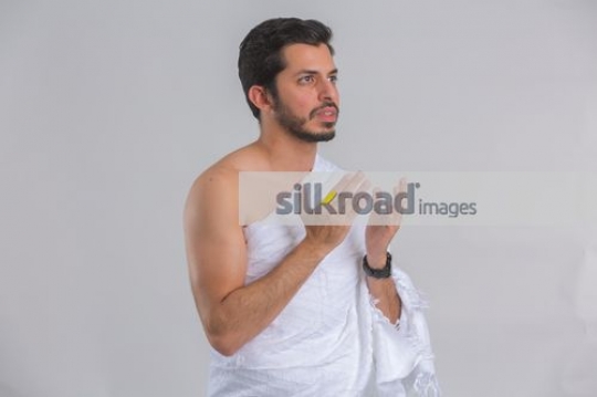Medium shot of a Young Middle Eastern man praying|