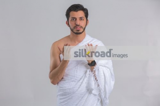 Young Middle Eastern man praying|