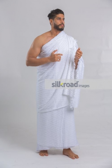 Middle Eastern man dressed in the religious attire|